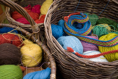 Basket of multicoloured yarn and tablet woven braids