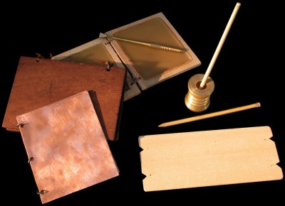Roman writing materials. wax tablets, wooden leaves writen on with ink and reed pens. Bronze  Diploma.