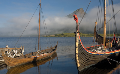 Viking ships with mist in the background.